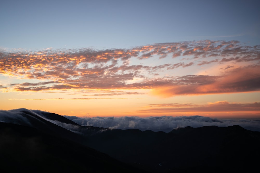 silhouette photo of mountains during golden hour