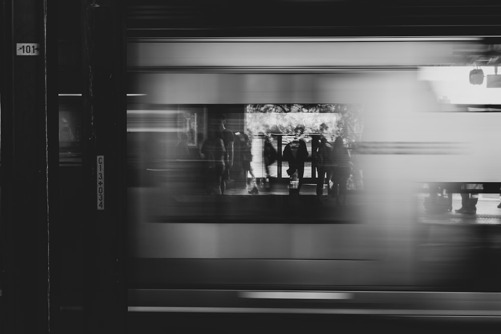 grayscale photography of photo displayed on glass window of store