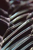 Close-up of a glass cutting process with sharp tools and sparkling glass shards.