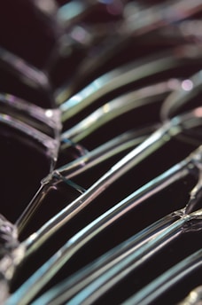 Close-up of a glass cutting process with sharp tools and sparkling glass shards.