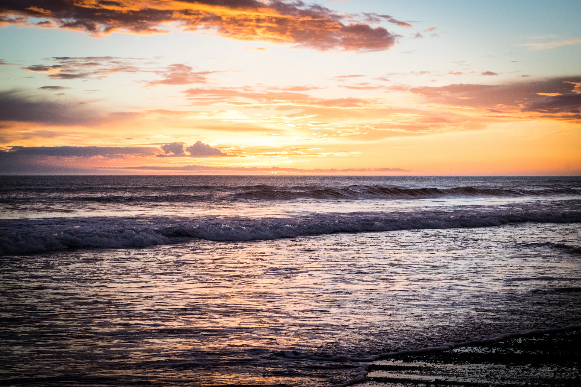 woman wearing yellow long-sleeved dress under white clouds and blue sky during daytime