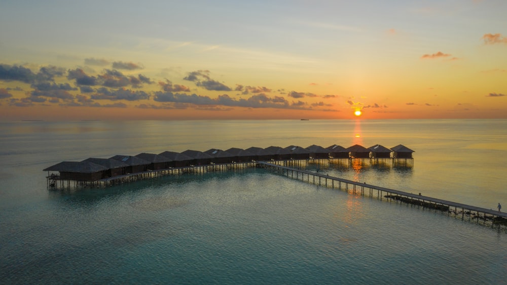 aerial photography of above water huts and bridge at daytime