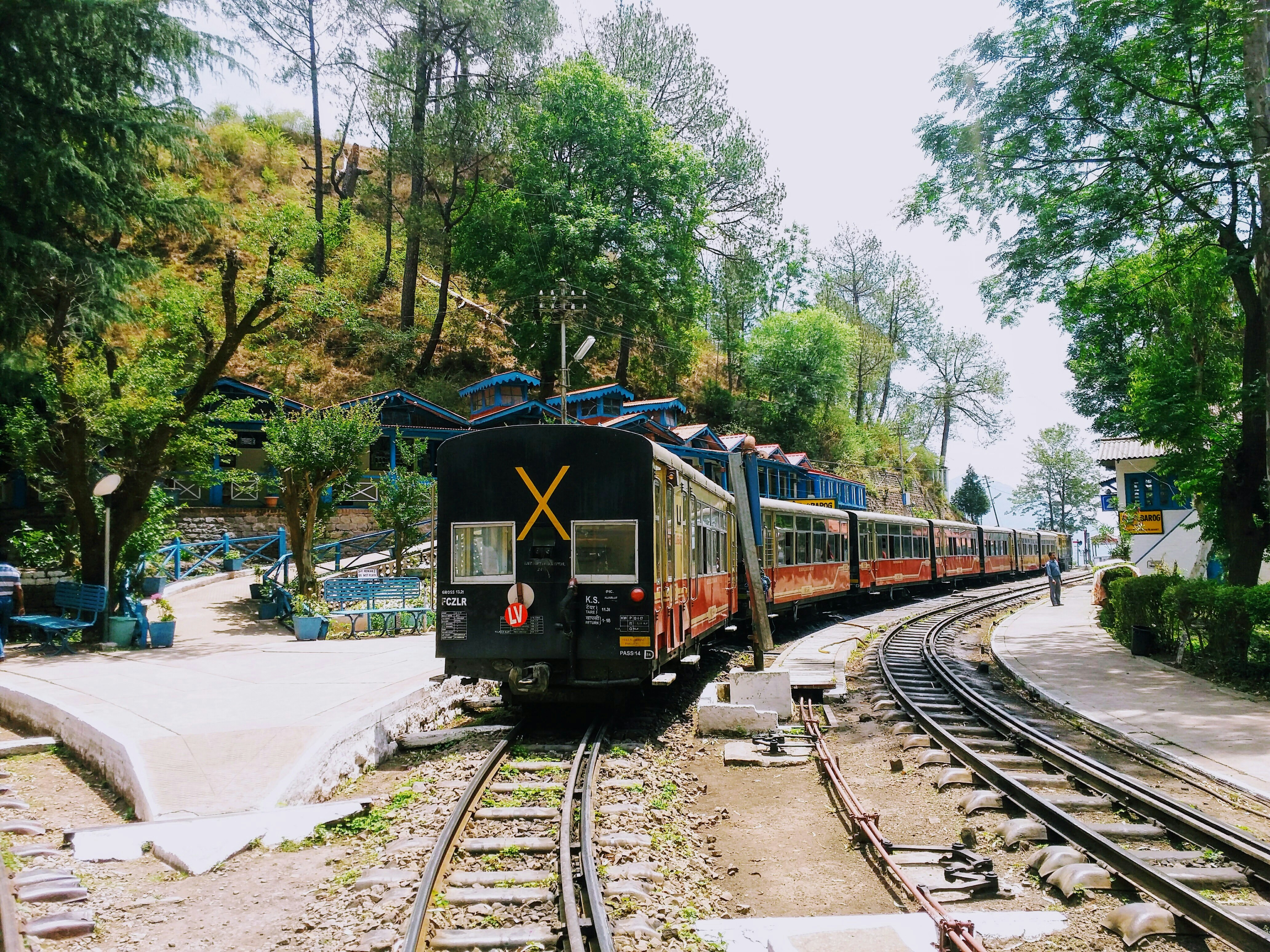 Black and red train on train tracks in the forest photo Free Himachal pradesh 173211 Image on