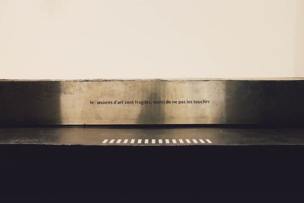 a metal bench with a quote on it