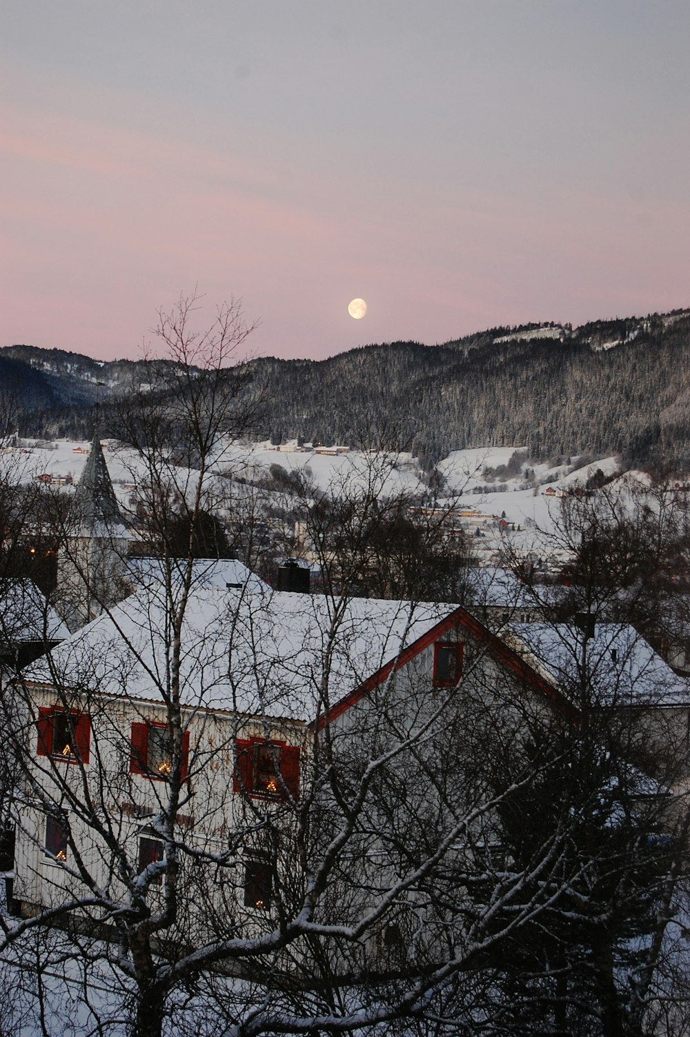 snow covered house during golden hour