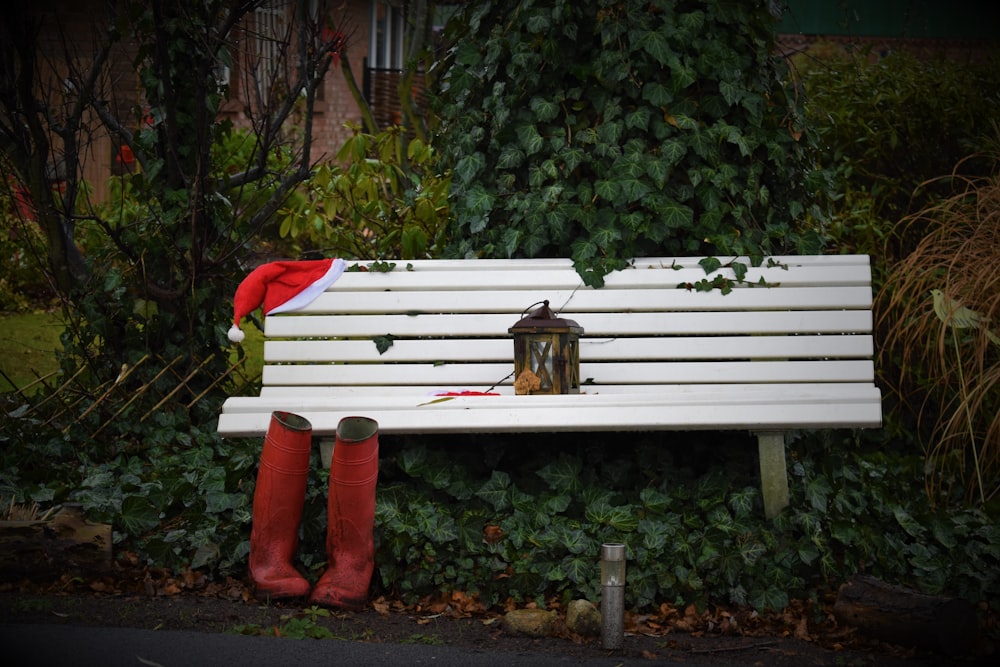 pair of red boots near white bench