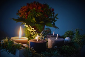 lighted candle beside another 3 candles