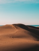 A serene desert landscape with rolling sand dunes.