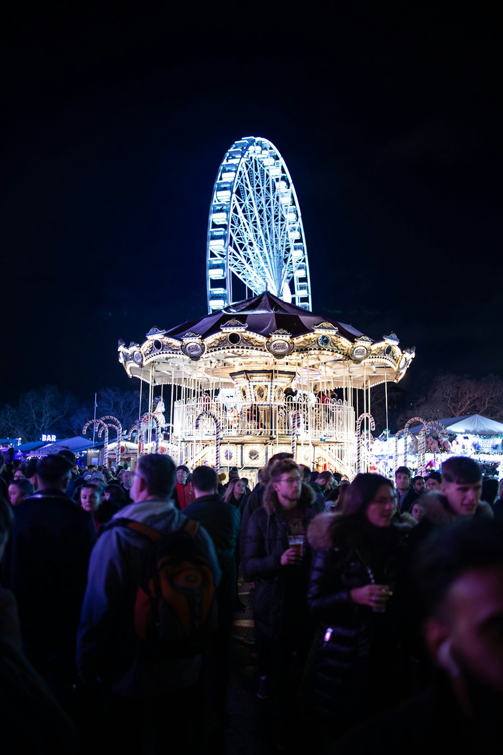 people standing near carousel during night time