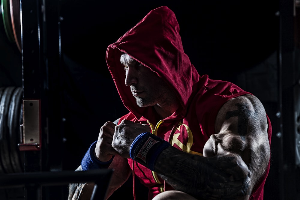 man wearing red hooded vest