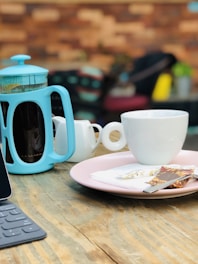 An inviting shot of a single-serve coffee pack next to a small French press.