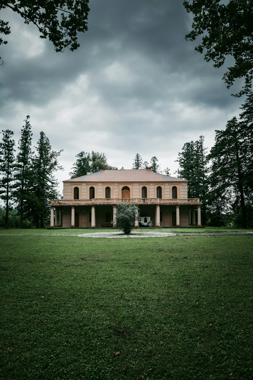 brown concrete house under cloudy sky