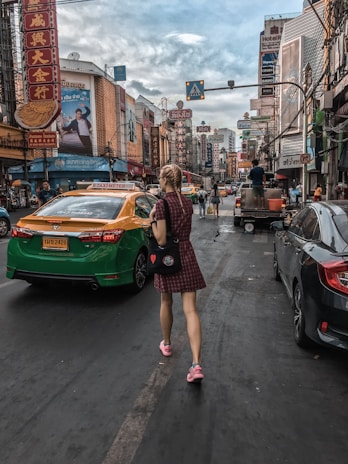 A lively African city street showcasing large, colorful billboards with diverse people interacting around them.