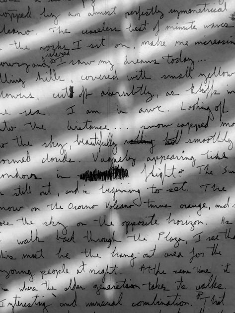 Close-up of handwritten cursive text filling a page, representing search queries written out as full sentences