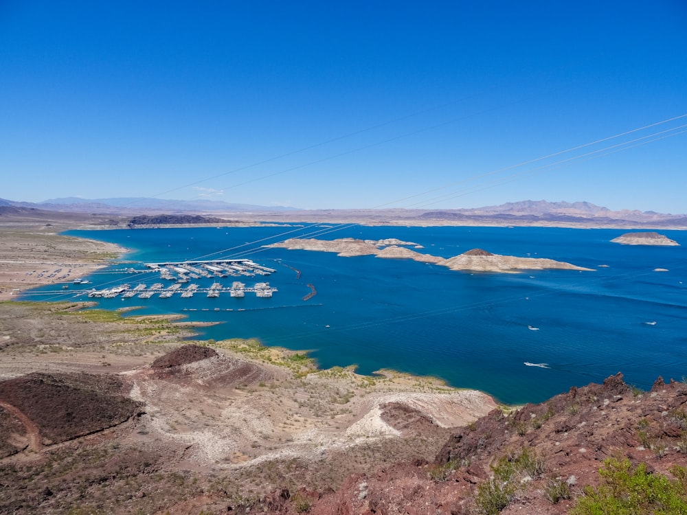 aerial photo of brown field and blue sea during daytime