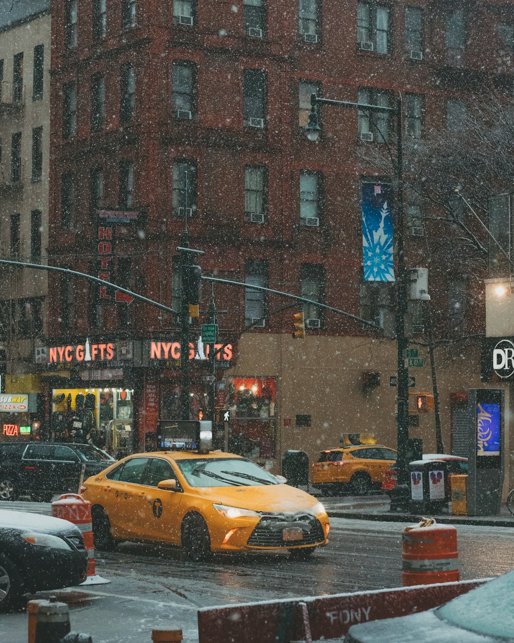 yellow taxi traveling on road