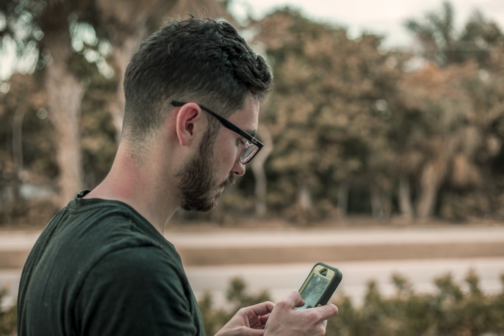 man looking down on his phone