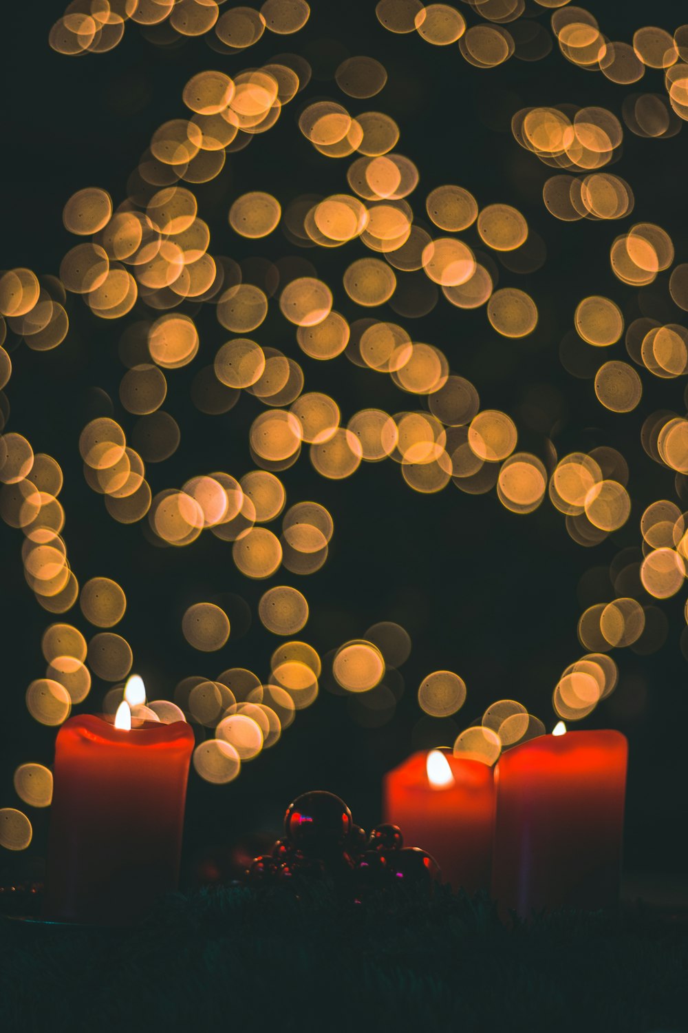 three lighted pillar candles