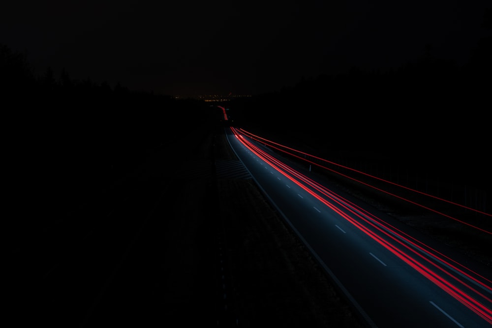time-lapse photography of vehicles passing on road