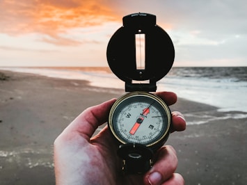 person holding compass