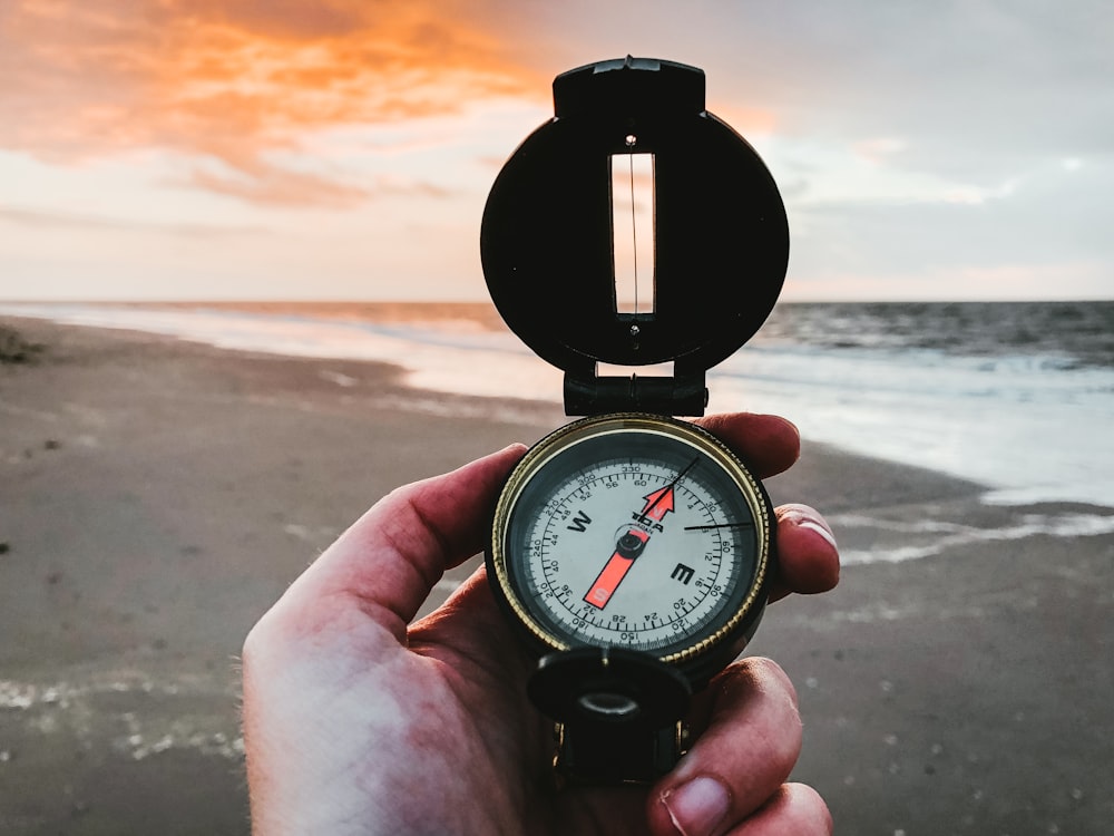 person holding compass