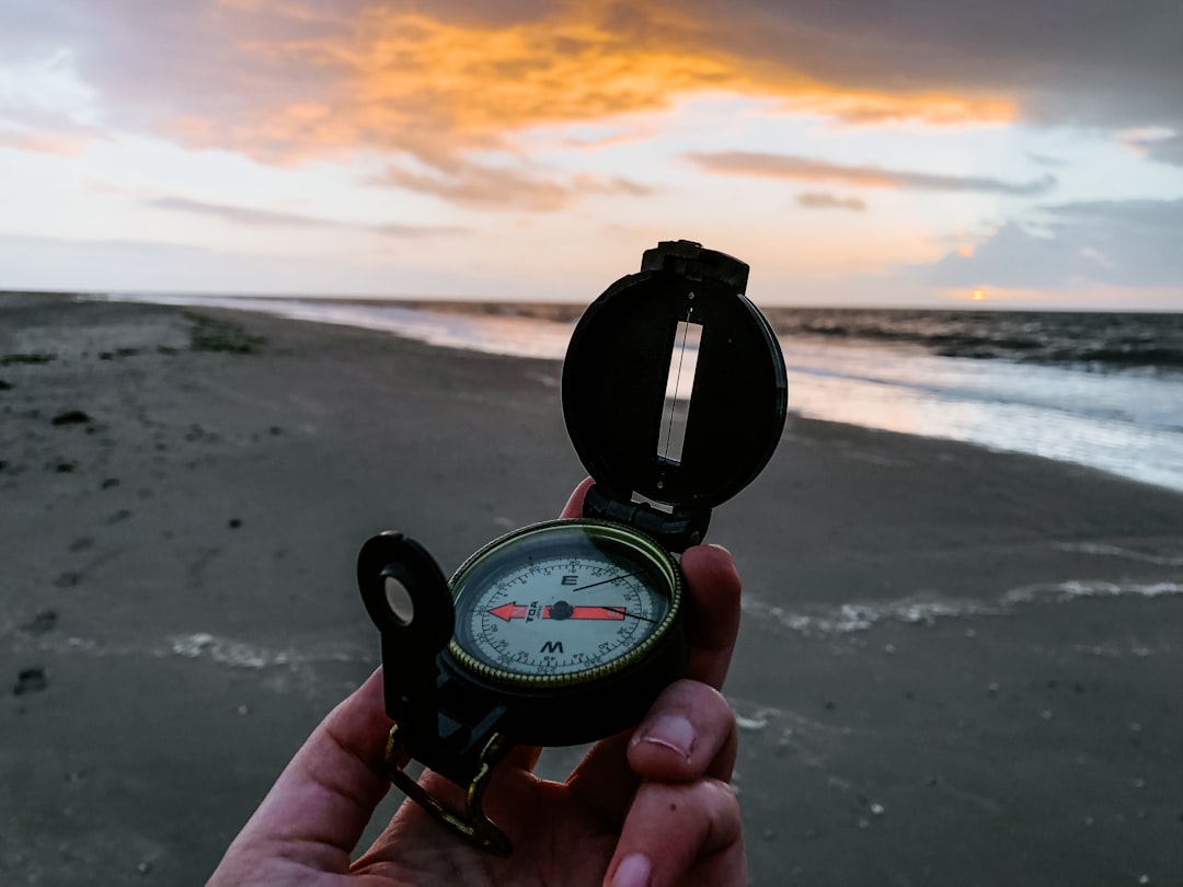 person holding black and white compass