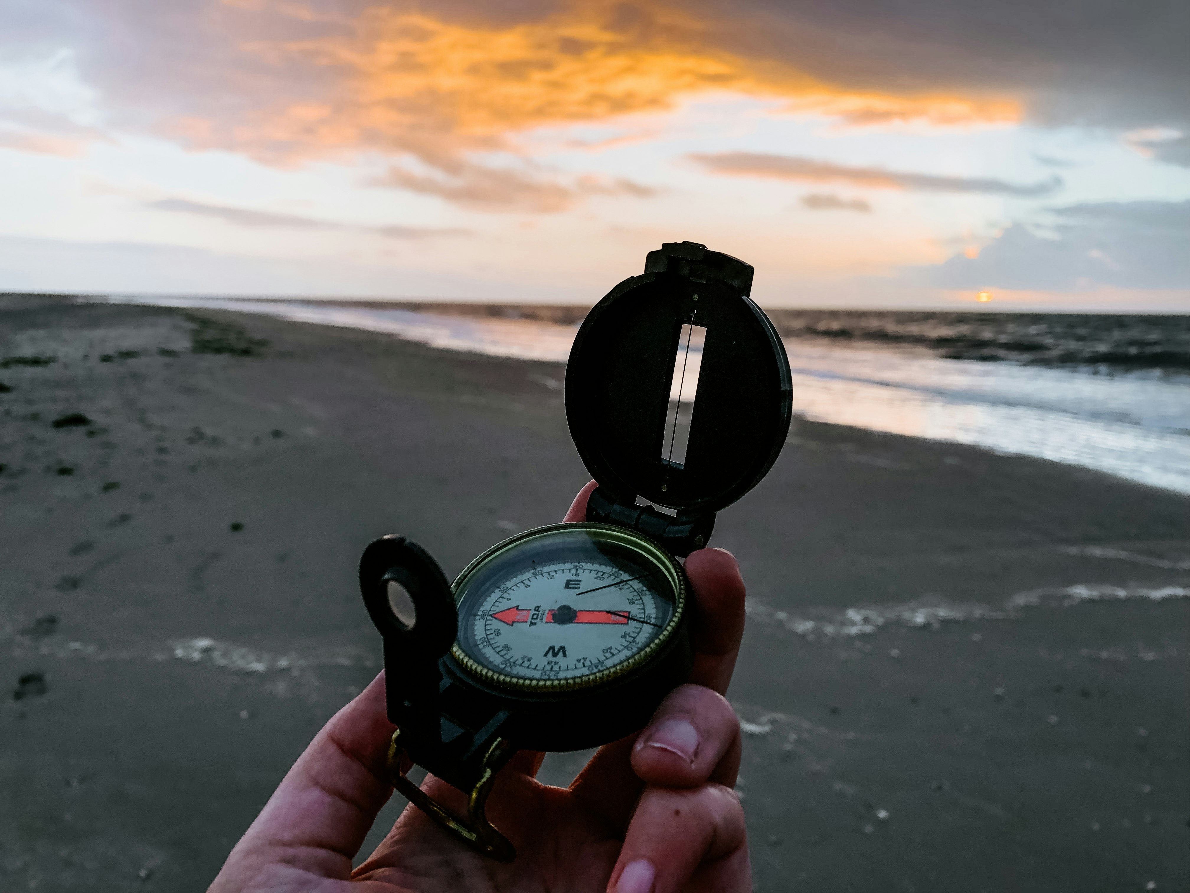 person holding black and white compass