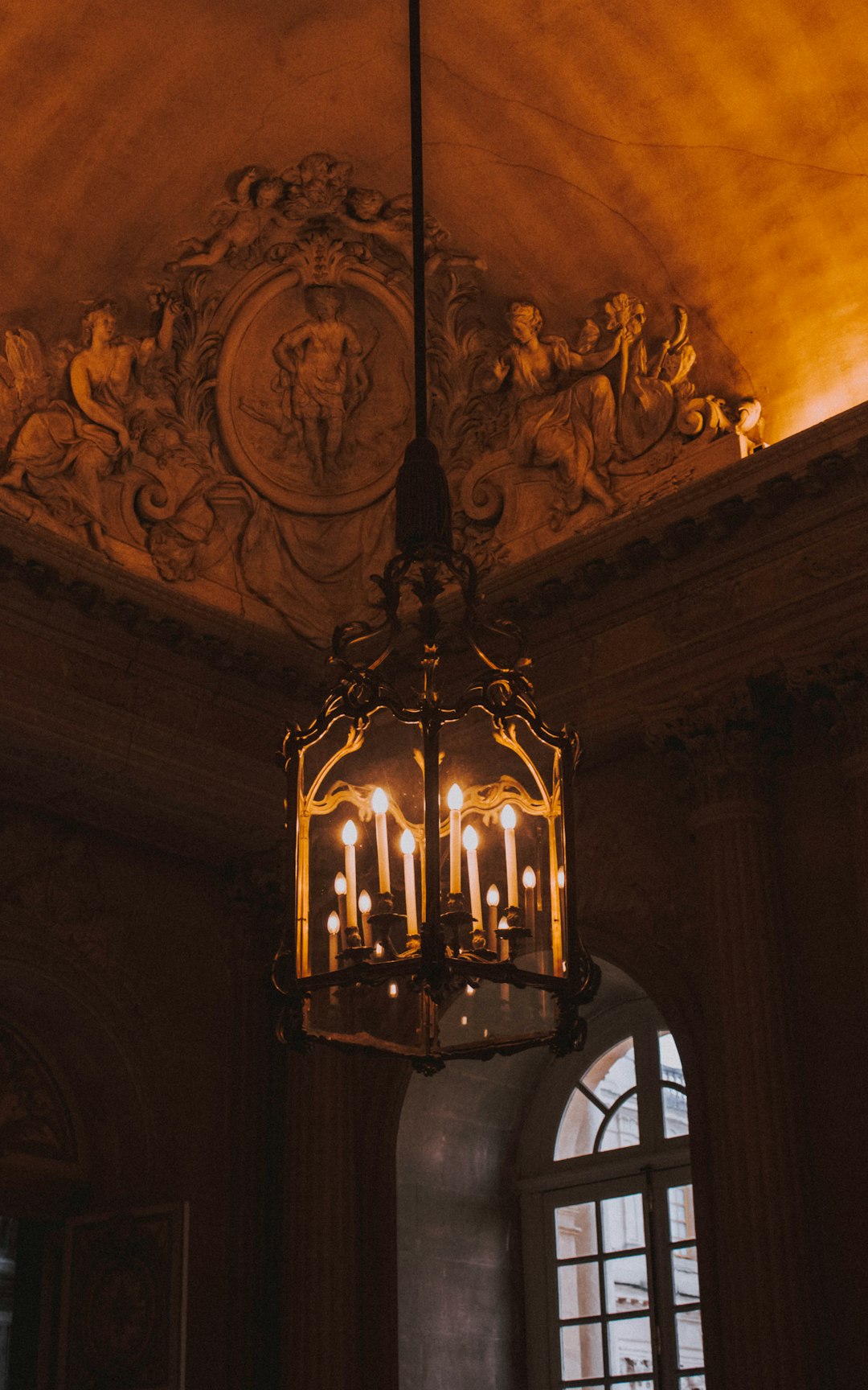 brass glass covered chandelier lighted up