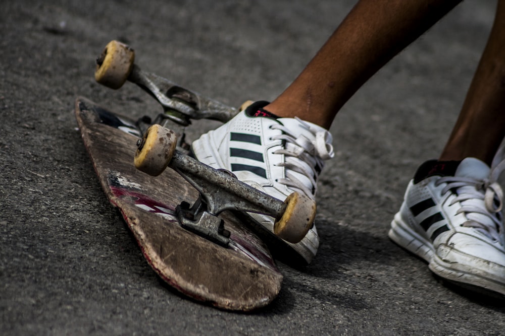 person wearing sneakers kicking skateboard during daytime photo – Free  Image on Unsplash