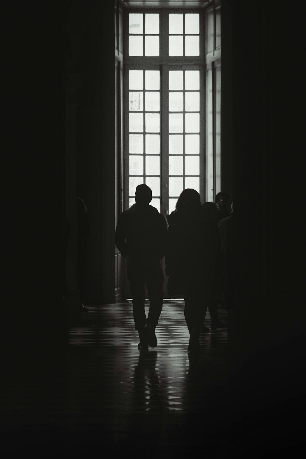 a group of people standing in front of a window