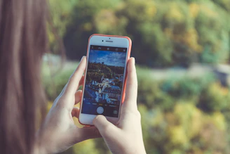 A happy traveler using a smartphone with a scenic Brazilian cityscape in the background.