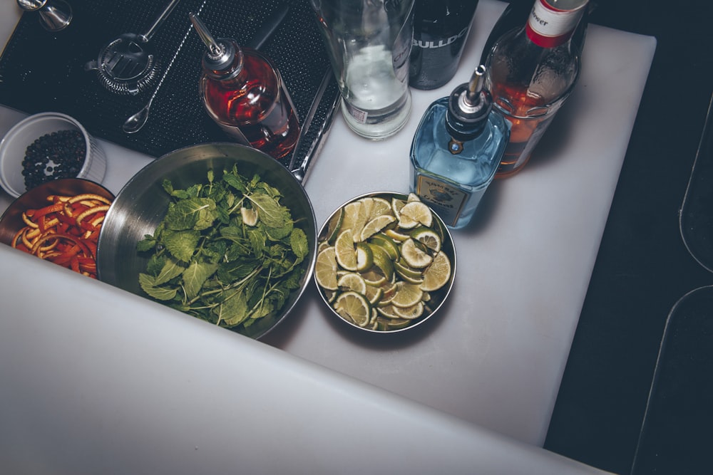 sliced limes on round stainless steel bowl