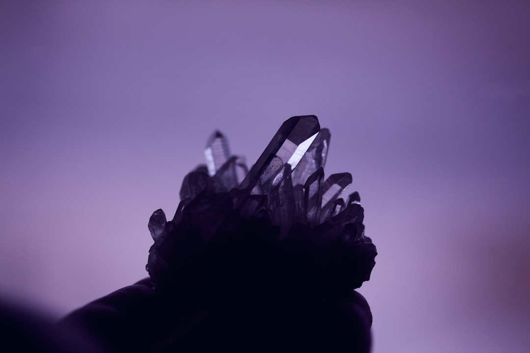 black and white floral textile, Still life of a natural quartz crystal cluster with purple background.