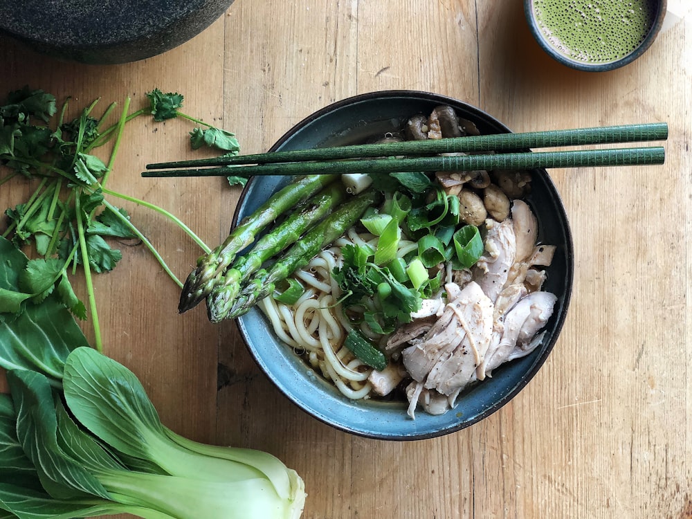 flat lay photography of pasta with asparagus in bowl