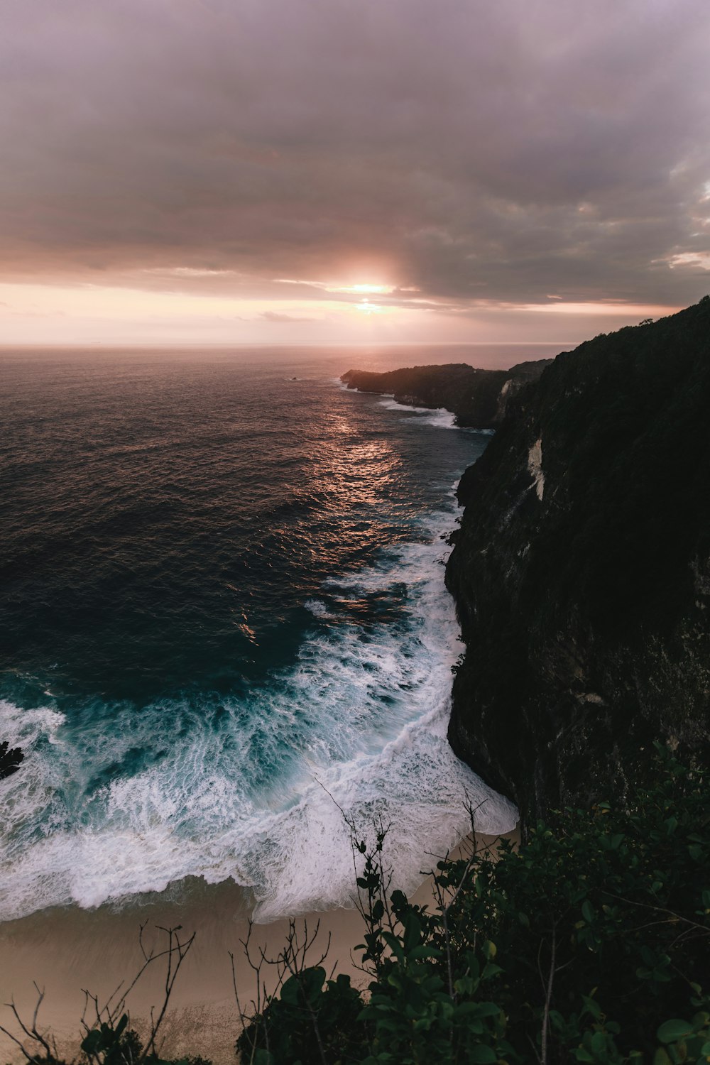 seashore across horizon during cloudy sunset