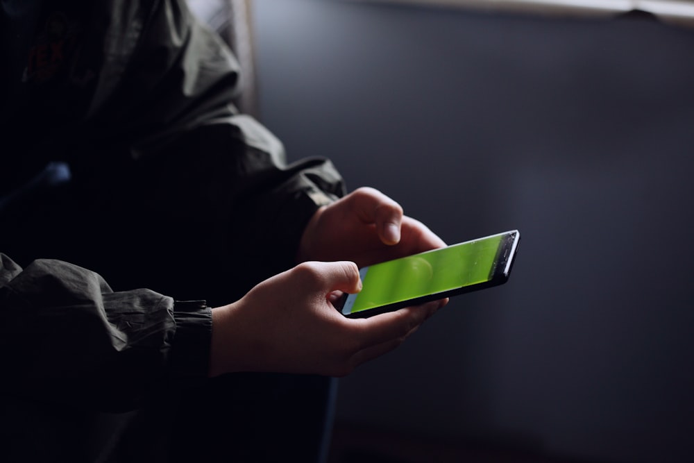 person holding black smartphone