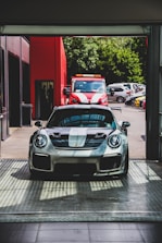 silver Porsche Carrera sports car on pavement