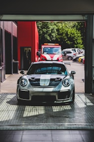 silver Porsche Carrera sports car on pavement