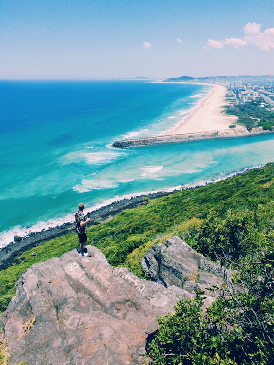 man standing on brown rock in Burleigh Head National Park Australia