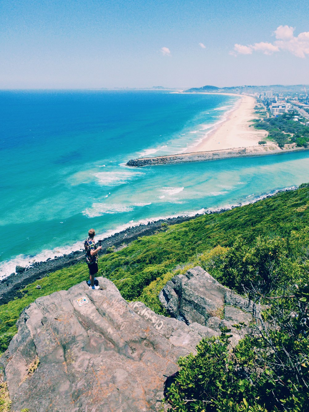 man standing on brown rock