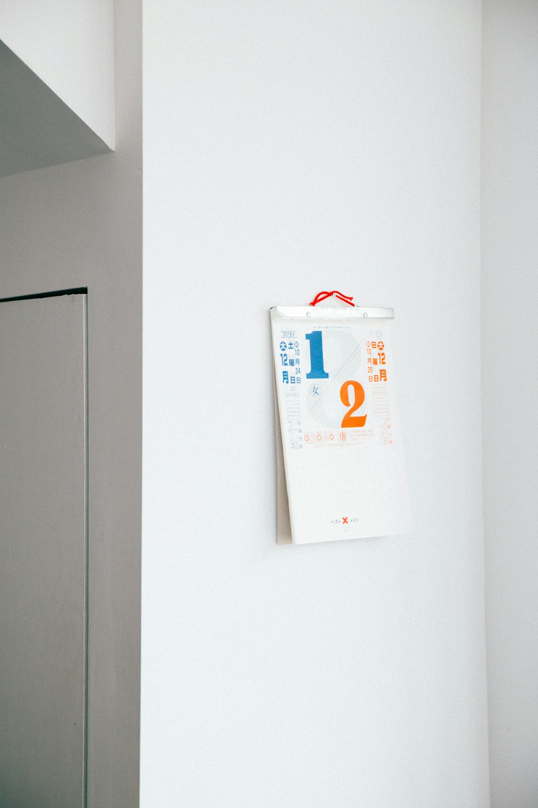 calendar hanging on white wall