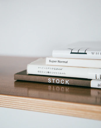 Elegant stack of books with a minimalist design on a clean white background.
