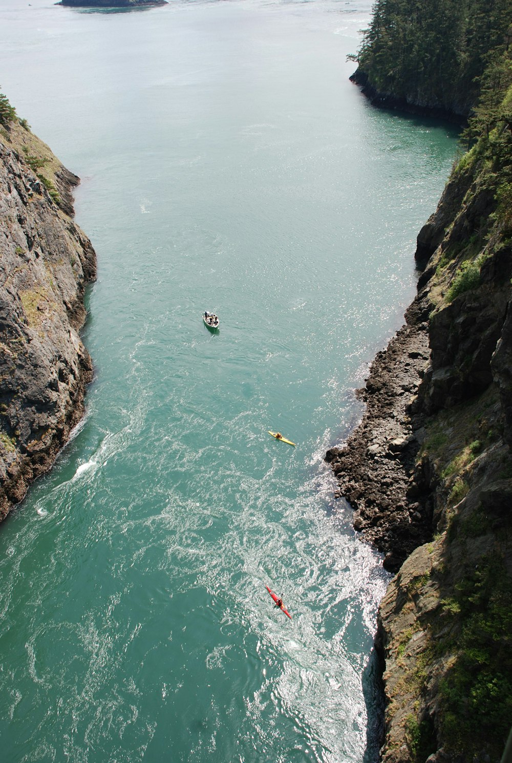 high-angle photography of beach between rocky mountain