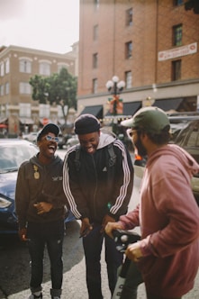 three men in jacket laughing at each other