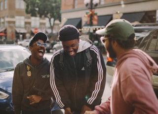 three men in jacket laughing at each other