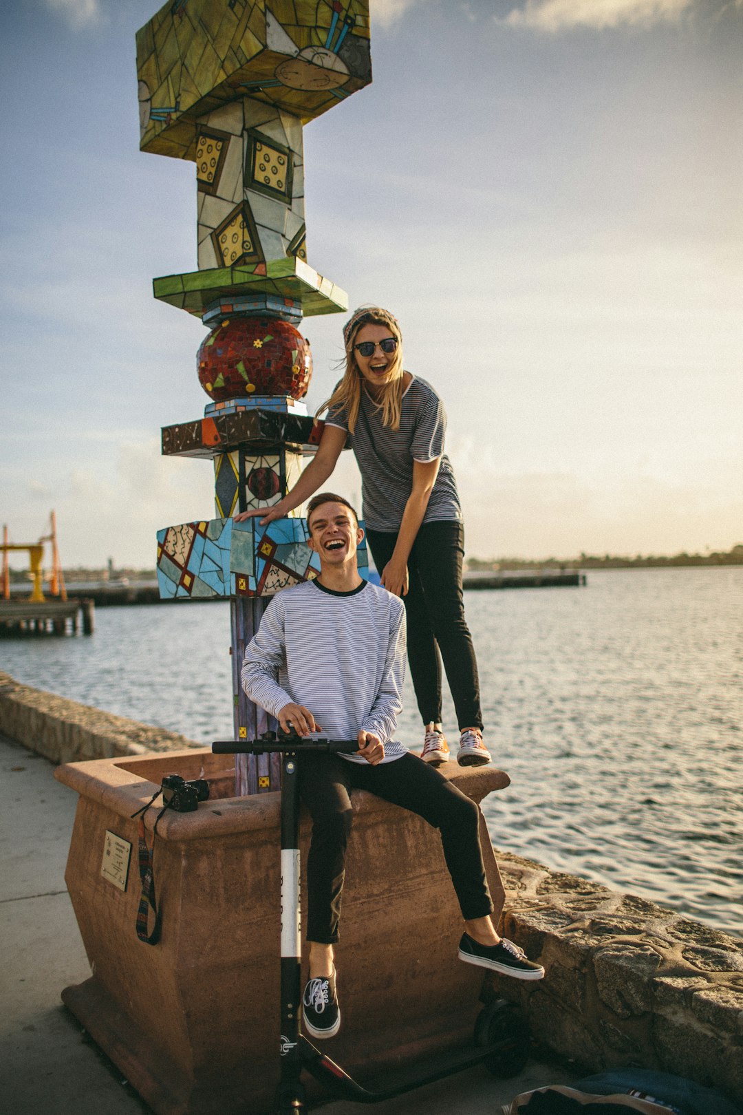 man and woman sitting beside beach