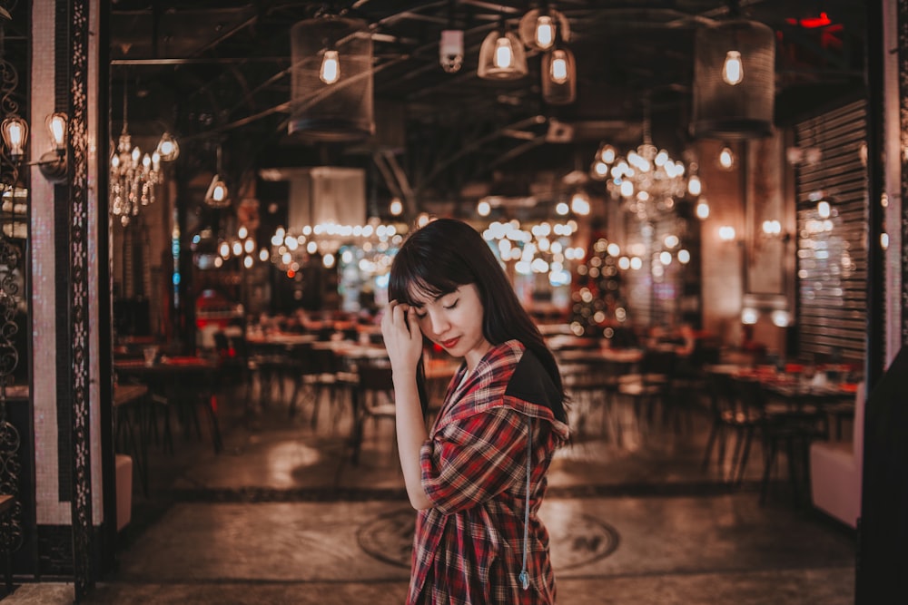 woman touching her hair while closing her eyes