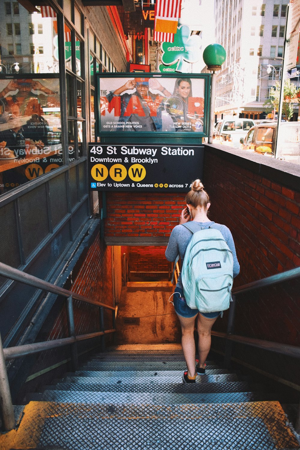 woman stepping down to subway station
