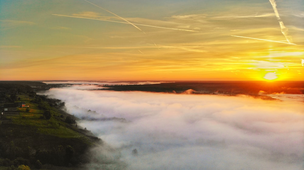 sea of clouds photo during golden hour