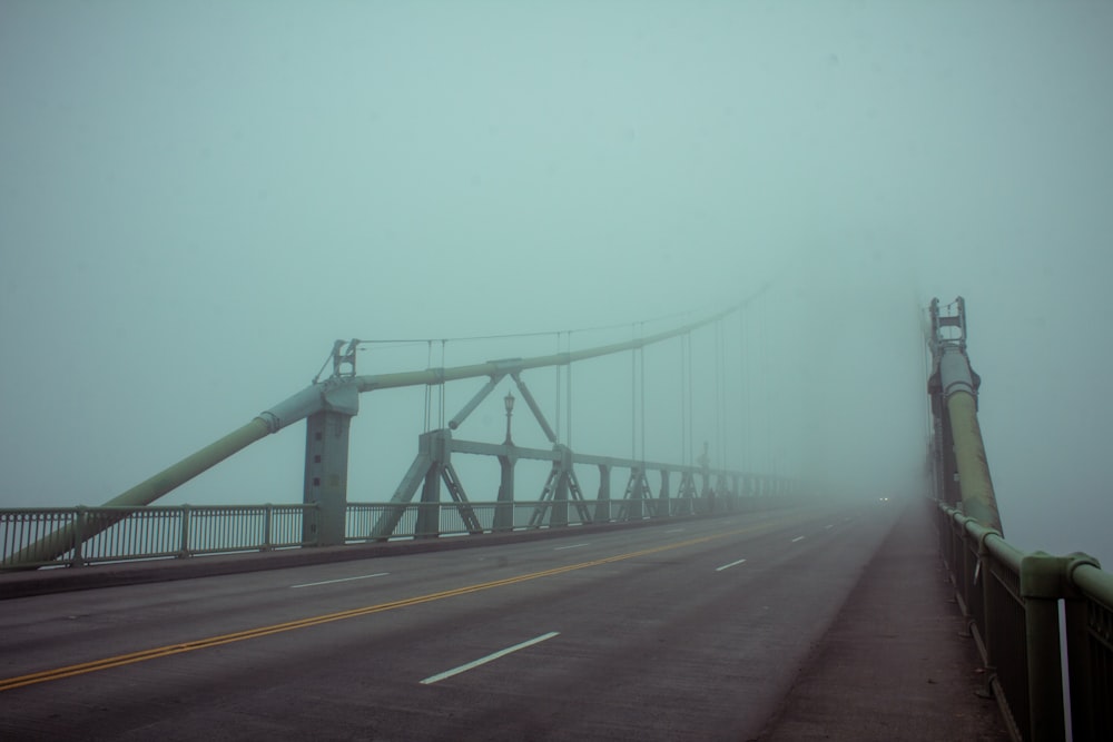 suspension bridge covered with fogs